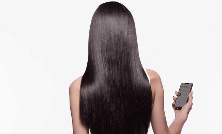 Woman with shiny long brown hair using an online hair diagnostic to wisely choose the most suitable hair care routine products